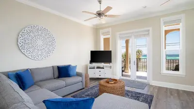 a living room with a couch and a flat screen tv at Walk To The Beach! 3 Story Home! 2 Balconies With Gulf Views! in Panama City Beach