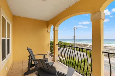 a balcony with chairs and a view of the ocean at Walk To The Beach! 3 Story Home! 2 Balconies With Gulf Views! in Panama City Beach