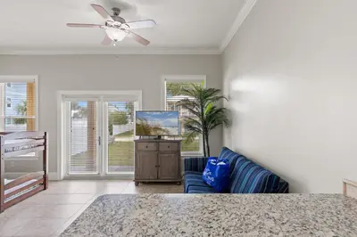 a living room with a ceiling fan and a couch at Walk To The Beach! 3 Story Home! 2 Balconies With Gulf Views! in Panama City Beach