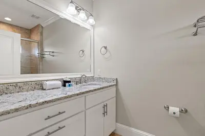 a bathroom with a sink and a large mirror at Walk To The Beach! 3 Story Home! 2 Balconies With Gulf Views! in Panama City Beach