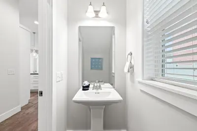 a white bathroom with a sink and a mirror at Fabulous Modern Beach House - 4BR, 35BA: POOL/Beach View & Access/Balcony in Panama City Beach