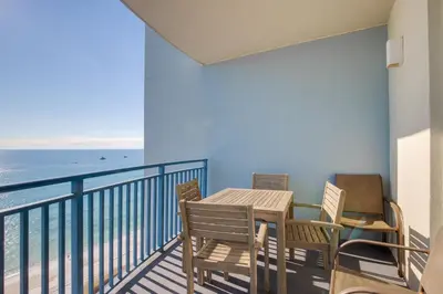 a balcony with a table and chairs and the ocean at Sterling Breeze 1105 in Panama City Beach