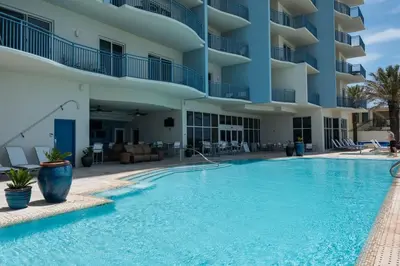 a swimming pool in front of a building at Sterling Breeze 1105 in Panama City Beach
