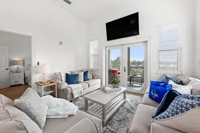 a living room with two couches and a tv at Remarkably Updated 3/2 in Seagrove Highlands - Gulf Views Sleeps 9! in Santa Rosa Beach