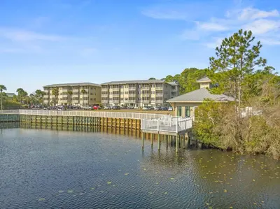 a view of a body of water with buildings in the background at Remarkably Updated 3/2 in Seagrove Highlands - Gulf Views Sleeps 9! in Santa Rosa Beach