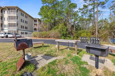a group of benches in a park in front of a building at Remarkably Updated 3/2 in Seagrove Highlands - Gulf Views Sleeps 9! in Santa Rosa Beach