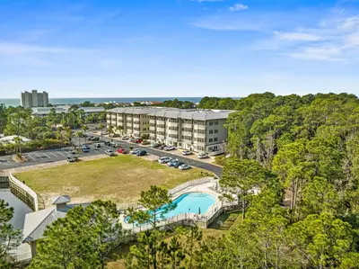 an aerial view of a resort with a pool and a parking lot at Remarkably Updated 3/2 in Seagrove Highlands - Gulf Views Sleeps 9! in Santa Rosa Beach