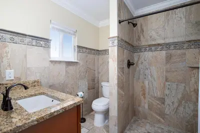 a bathroom with a toilet and a shower at Directly On The Beach! First Floor Sundeck! Near Pier Park! Sleeps 6! in Panama City Beach