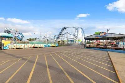 an empty amusement park with a roller coaster at Directly On The Beach! First Floor Sundeck! Near Pier Park! Sleeps 6! in Panama City Beach