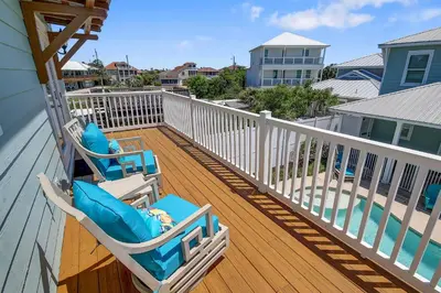 a deck with two lounge chairs on a house at 5 Bed, 5 Bath Beach Home/Only a 3 Minute Walk To The Beach! SLEEPS 12 in Panama City Beach