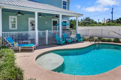 a swimming pool in front of a house at 5 Bed, 5 Bath Beach Home/Only a 3 Minute Walk To The Beach! SLEEPS 12 in Panama City Beach