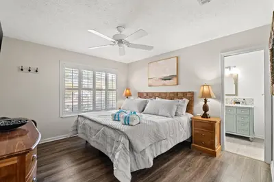 a bedroom with a bed and a ceiling fan at Contemporary Bungalow / West End PCB / Available NOW! / Perfect for Family in Panama City Beach
