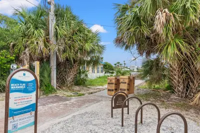 a sign in the middle of a road with palm trees at One Upon A Tide - Private Pool - Mother-In-Law Suite in Santa Rosa Beach