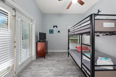 a bedroom with a bunk bed and a tv at One Upon A Tide - Private Pool - Mother-In-Law Suite in Santa Rosa Beach