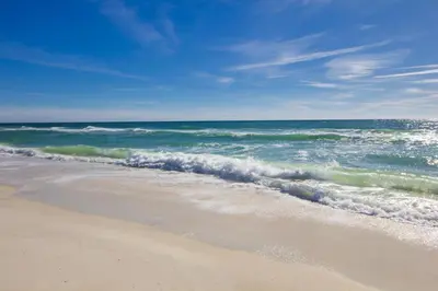 a beach with the ocean on a sunny day at One Upon A Tide - Private Pool - Mother-In-Law Suite in Santa Rosa Beach