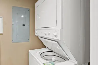 a white washer and dryer in a bathroom at Gulf Front Living Room AND Master Suite! SLEEPS 8! in Panama City Beach