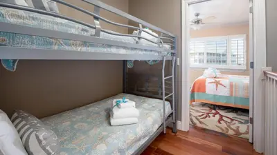 a bedroom with two bunk beds in a room at Beautiful Townhome Right On The Gulf - Get Ready To Relax! in Panama City Beach