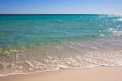 a sandy beach with the ocean in the background at Beautiful Townhome Right On The Gulf - Get Ready To Relax! in Panama City Beach