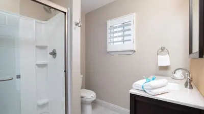 a bathroom with a shower and a sink and a toilet at Beautiful Townhome Right On The Gulf - Get Ready To Relax! in Panama City Beach