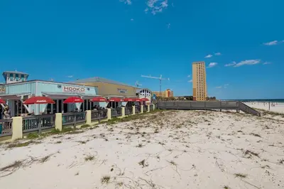 a restaurant with red umbrellas on the beach at Beautiful Townhome Right On The Gulf - Get Ready To Relax! in Panama City Beach