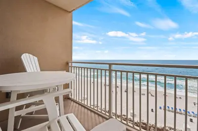 a balcony with a table and chairs and the ocean at Emerald Beach Resort by Blue Swell in Panama City Beach