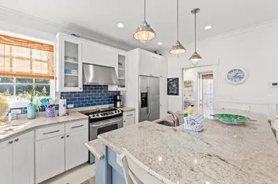 a kitchen with white cabinets and a counter top at Quaint 2BR/25BA Cottage Nestled Between 30A & Panama City Beach! Sleeps 6! in Panama City Beach