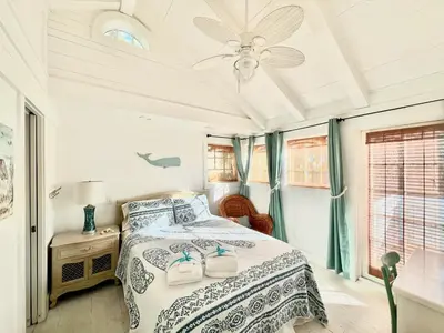 a bedroom with a bed and a ceiling fan at Quaint 2BR/25BA Cottage Nestled Between 30A & Panama City Beach! Sleeps 6! in Panama City Beach