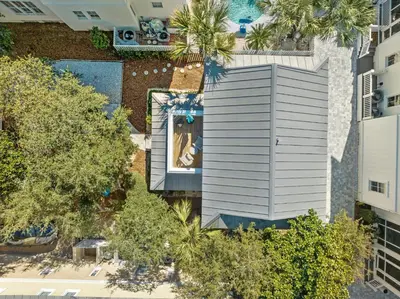 an overhead view of a building with a swimming pool at Quaint 2BR/25BA Cottage Nestled Between 30A & Panama City Beach! Sleeps 6! in Panama City Beach