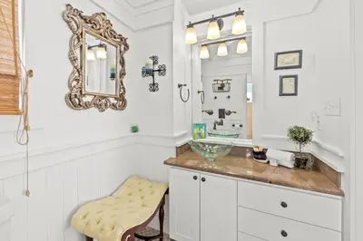 a bathroom with a sink and a mirror at Quaint 2BR/25BA Cottage Nestled Between 30A & Panama City Beach! Sleeps 6! in Panama City Beach