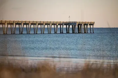 a pier in the water with the ocean at Across Street from Beach - Close to Pier Park - Sleeps 6! in Panama City Beach