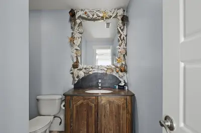 a bathroom with a sink and a mirror at Luxury Gulf Front Property! Directly on the Beach! Sleeps 15! in Panama City Beach