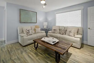 a living room with two couches and a coffee table at Luxury Gulf Front Property! Directly on the Beach! Sleeps 15! in Panama City Beach