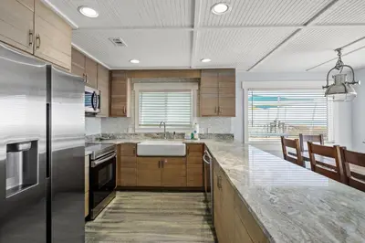 a kitchen with a sink and a refrigerator at Luxury Gulf Front Property! Directly on the Beach! Sleeps 15! in Panama City Beach