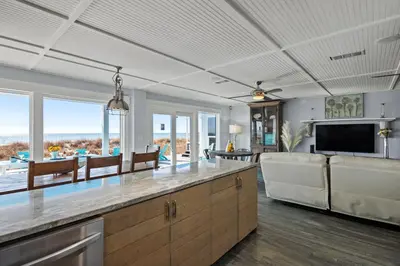 a kitchen and living room with a view of the ocean at Luxury Gulf Front Property! Directly on the Beach! Sleeps 15! in Panama City Beach