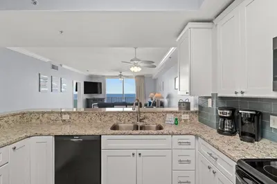 a kitchen with white cabinets and a sink at Tidewater Beach Luxury Penthouse with Resort Amenities and a View! in Panama City Beach