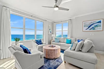 a living room with a couch and chairs and a table at Luxury Beachfront Condo w/ 2 Balconies! Sleeps 8! Walk to Pier Park! in Panama City Beach