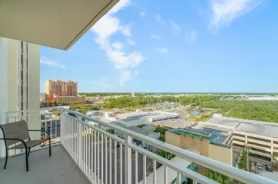 a balcony with a view of a city at Luxury Beachfront Condo w/ 2 Balconies! Sleeps 8! Walk to Pier Park! in Panama City Beach