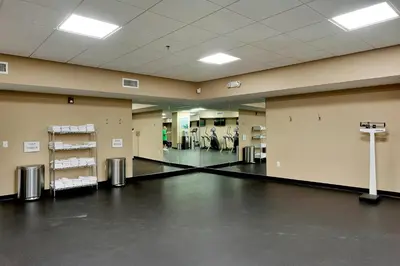 a large room with a gym with white towels at Brand New Throughout! Emerald Beach - Gulf Front! Sleeps 8! in Panama City Beach