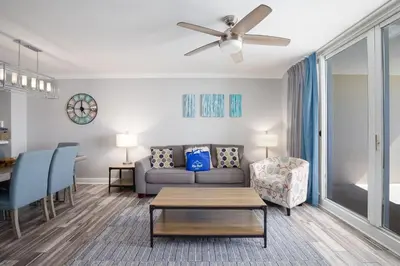 a living room with a couch and a table at Brand New Throughout! Emerald Beach - Gulf Front! Sleeps 8! in Panama City Beach