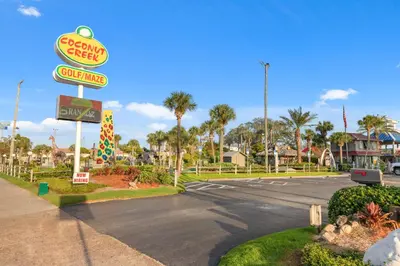 a sign for a fast food restaurant on a street at End Unit - Directly On The Gulf! Sleeps 6! Italian Luxury Furnishings! in Panama City Beach
