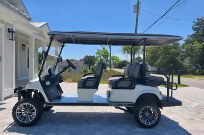 a golf cart parked in front of a house at Brand New Home with In-ground Pool, Four Houses From Beautiful Laguna Beach in Panama City Beach
