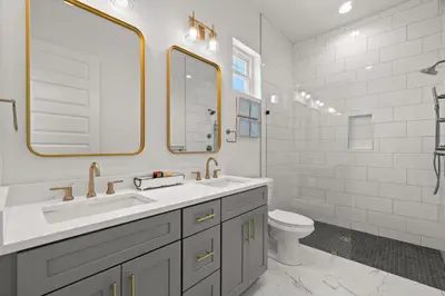 a white bathroom with a sink and a toilet at Brand New Home with In-ground Pool, Four Houses From Beautiful Laguna Beach in Panama City Beach