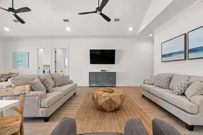 a living room with two couches and a tv at Brand New Home with In-ground Pool, Four Houses From Beautiful Laguna Beach in Panama City Beach