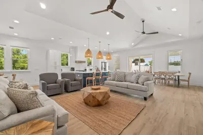 a living room with two couches and a table at Brand New Home with In-ground Pool, Four Houses From Beautiful Laguna Beach in Panama City Beach