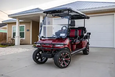 a golf cart parked in front of a house at Amazing New 3br/2ba Laguna Beach! / 6p GOLF CART: 2 mins to Beach/West PCB in Panama City Beach