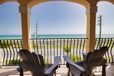 a porch with chairs and a view of the ocean at 2 Gulf View Balconies! 3 Story Townhome With 4 Bedrooms, 4 Bathrooms! Sleeps12 in Panama City Beach