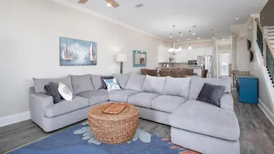 a living room with a gray couch and a table at 2 Gulf View Balconies! 3 Story Townhome With 4 Bedrooms, 4 Bathrooms! Sleeps12 in Panama City Beach