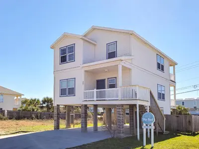 a white house with a sign in front of it at Summer Dayz - Families Love It Here, Just Across from the Beach in Panama City Beach