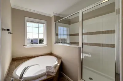 a bathroom with a bath tub and a shower at Summer Dayz - Families Love It Here, Just Across from the Beach in Panama City Beach