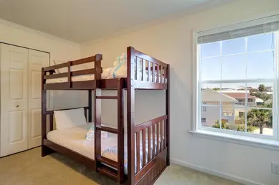 two bunk beds in a room with a window at Summer Dayz - Families Love It Here, Just Across from the Beach in Panama City Beach